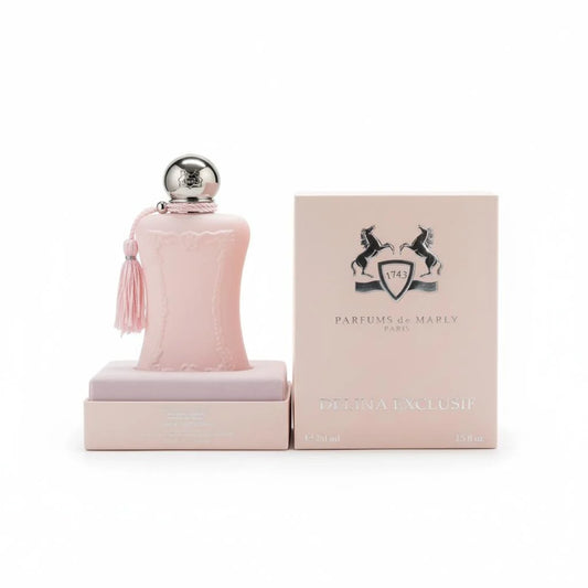 A light pink perfume bottle with a silver cap and tassel, displayed next to its matching pink packaging box featuring the Parfums de Marly logo.
