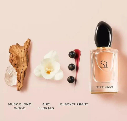 Giorgio Armani Si perfume bottle with floral and wood elements on a pink background