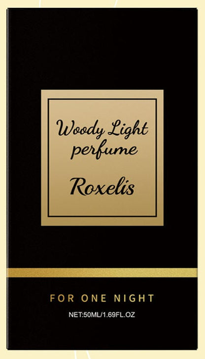 Roxelis Woody Light perfume bottle and box shown beside a lifestyle photo of a close couple, on a cream background with curved gold lines.