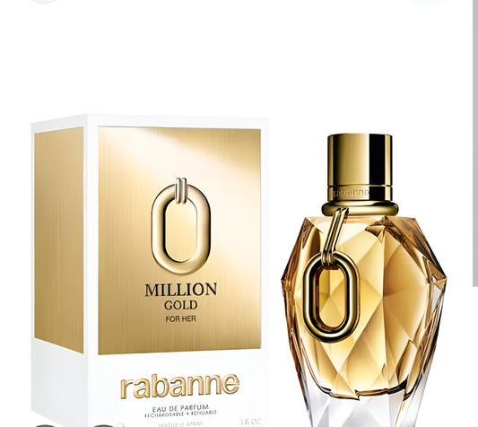 A bottle of Rabanne Million Gold For Her Eau de Parfum next to its white and gold packaging box, featuring a faceted gold glass bottle with a prominent gold O-shaped ring detail and a shiny gold cap.