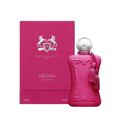 A bottle of Oriana Eau de Parfum by Parfums de Marly next to its matching pink packaging box, featuring a vibrant magenta pink color with a silver cap and tassel.