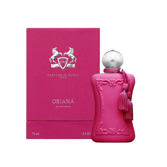 A bottle of Oriana Eau de Parfum by Parfums de Marly next to its matching pink packaging box, featuring a vibrant magenta pink color with a silver cap and tassel.