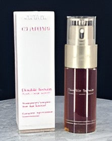 A bottle of Christian Dior Sauvage Elixir de Parfum next to its white packaging box, set against a dark background.