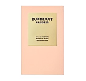 A pale peach notebook with a central cream-colored label that reads 'BURBERRY' in black text.