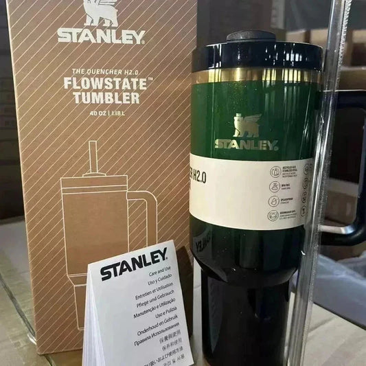 Stanley FlowState tumbler with packaging and user manual on a reflective surface.
