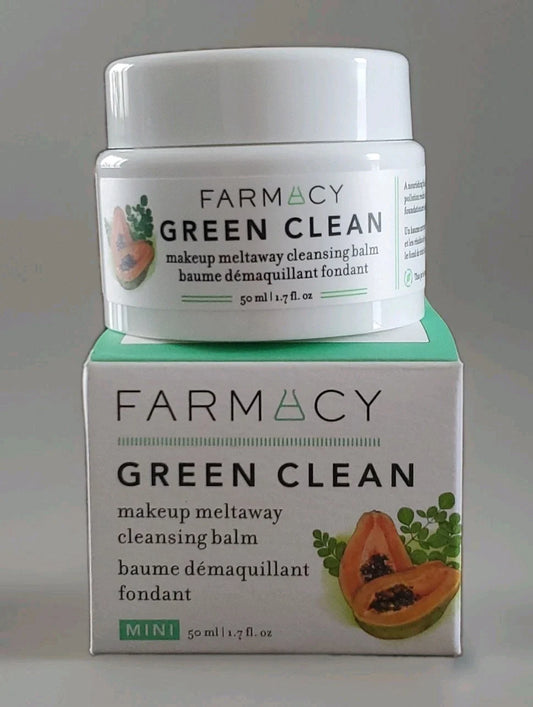 A white jar of Farmacy Green Clean makeup meltaway cleansing balm is displayed on top of its matching white and mint green retail box against a neutral gray background.