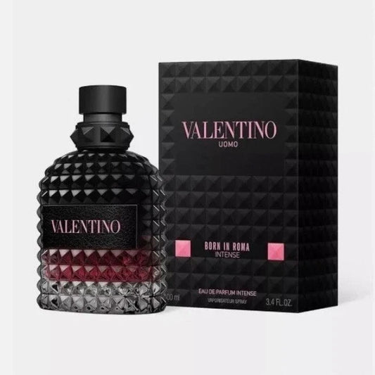 Valentino Uomo Born in Roma Intense Eau de Parfum bottle and packaging box. The bottle is a textured dark glass with a black cap and a pink label, showing a deep red liquid inside.