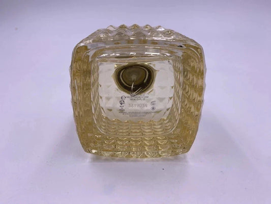 Clear glass square bowl with textured surface on a white background