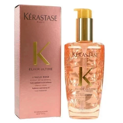 Kérastase Paris Elixir Ultimé Color Treated Hair Oil in Rose (L'Huile Rose), showing the faceted clear bottle filled with peachy rose-colored oil next to its metallic rose-pink packaging box with gold lettering.